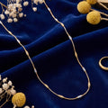 Gold chain with silver and gold cylindrical accents