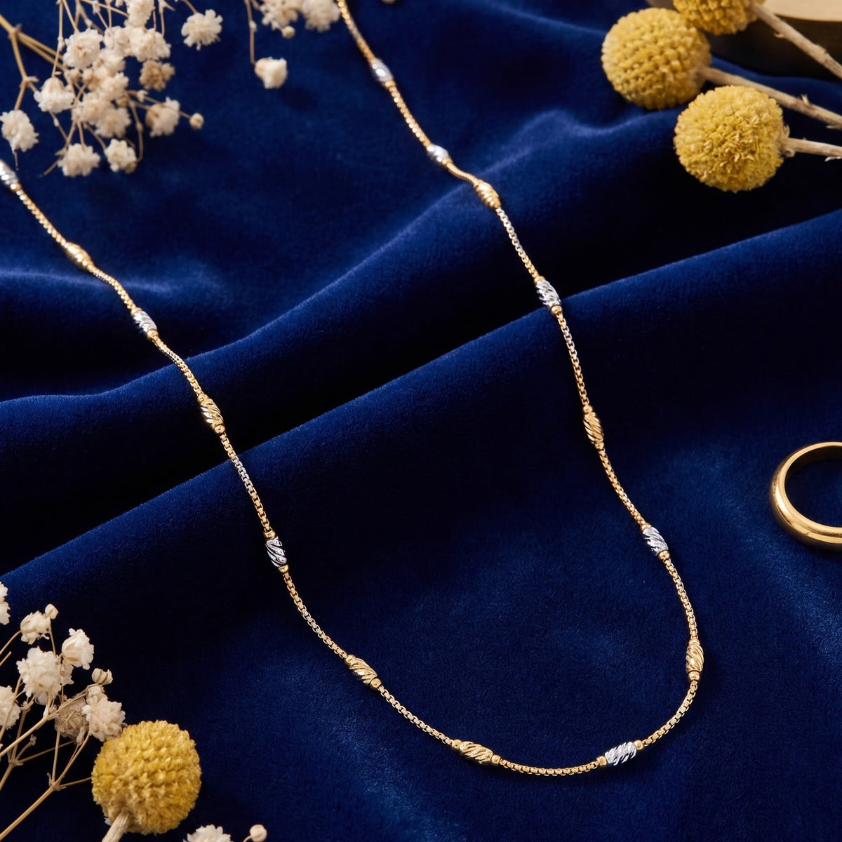 Gold chain with silver and gold cylindrical accents