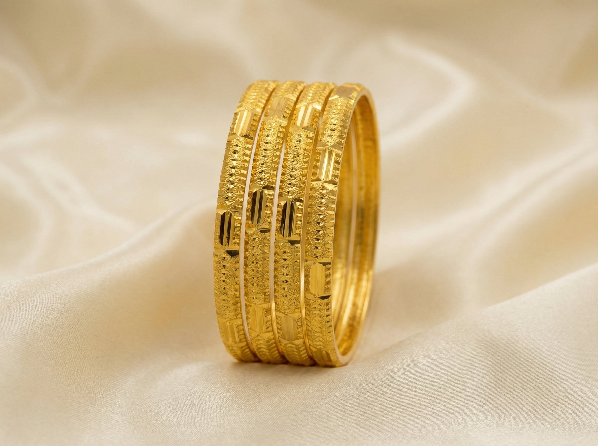 Round curved gold bangles