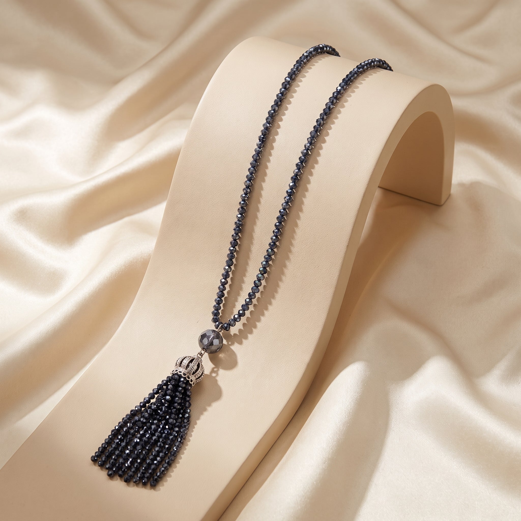 Long crystal necklace with crown style pendant