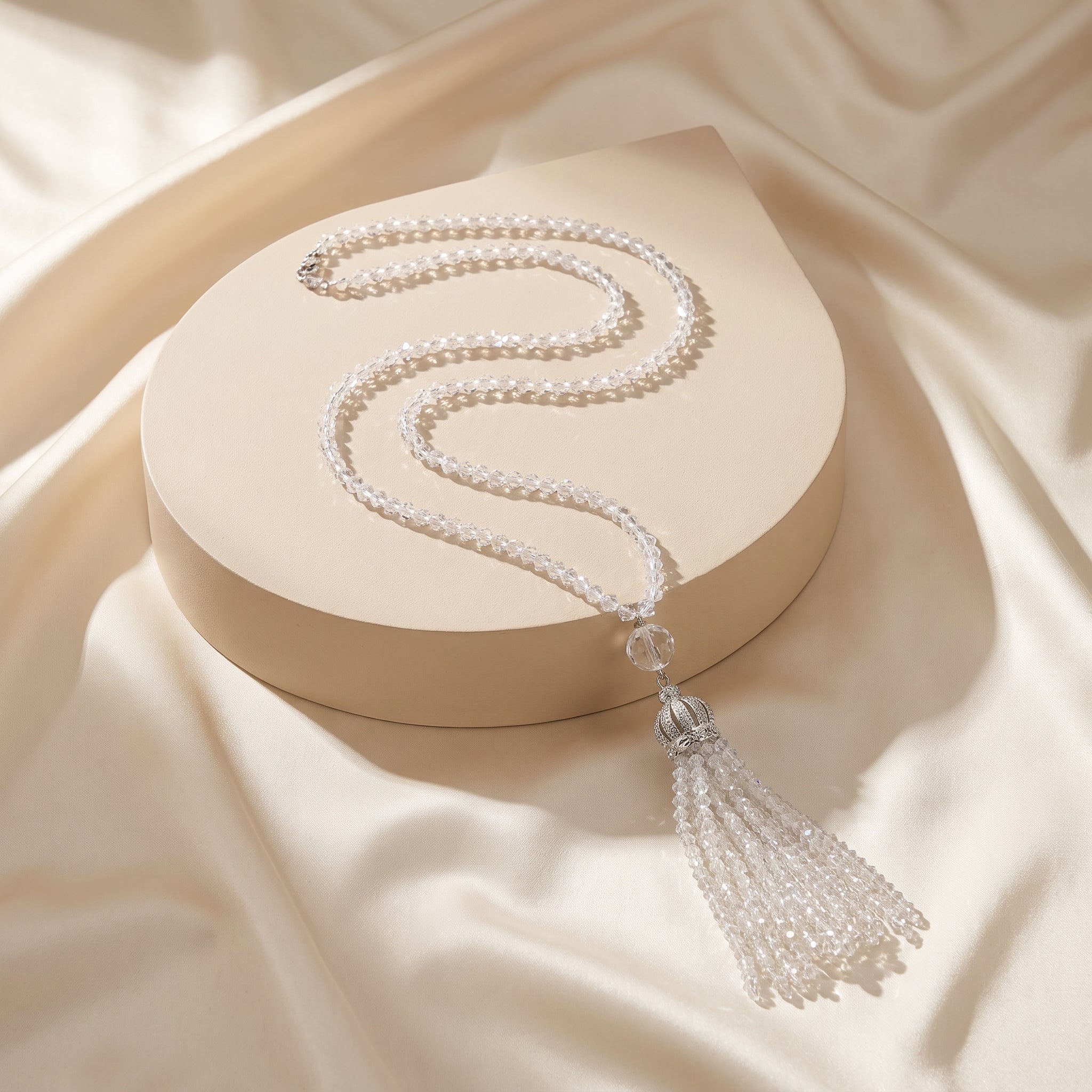 Long crystal necklace with crown style pendant